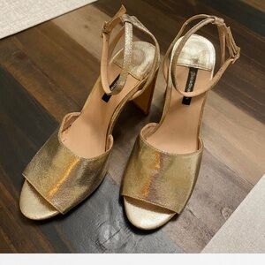 Gold high heel shoes